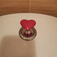 Botón de inodoro corazón